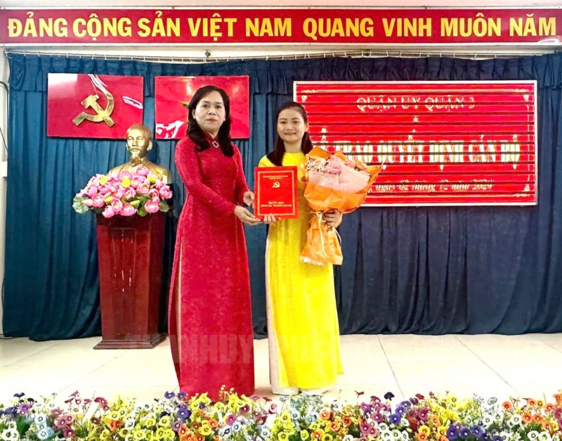 Bí thư Quận ủy Nguyễn Thanh Xuân trao quyết định cho đồng chí Trần Thị Xuân Hương.