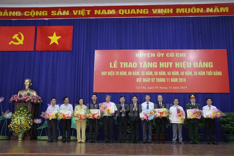 Lãnh đạo huyện Củ Chi trao Huy hiệu Đảng cho các đảng viên. (Ảnh: Kiều Ngân)