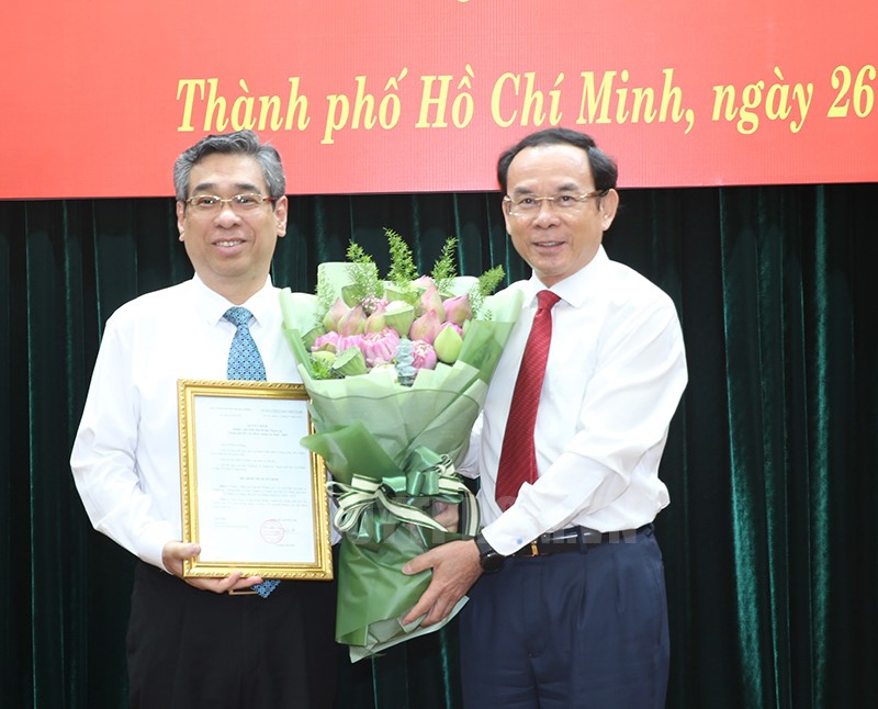 Đồng chí Nguyễn Văn Nên trao quyết định và tặng hoa chúc mừng đồng chí Nguyễn Phước Lộc