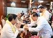 Đồng chí Phan Văn Mãi thực hiện nghi thức buộc chỉ cổ tay theo truyền thống Tết cổ truyền Lào