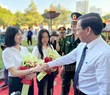 Ủy viên Trung ương Đảng, Phó Bí thư Thành ủy, Chủ tịch UBND TPHCM Phan Văn Mãi tặng hoa và động viên nữ thanh niên lên đường nhập ngũ.