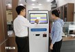 Cán bộ Trung tâm phục vụ hành chính công hướng dẫn người dân đến làm các thủ tục hành chính. (Ảnh: TTXVN)